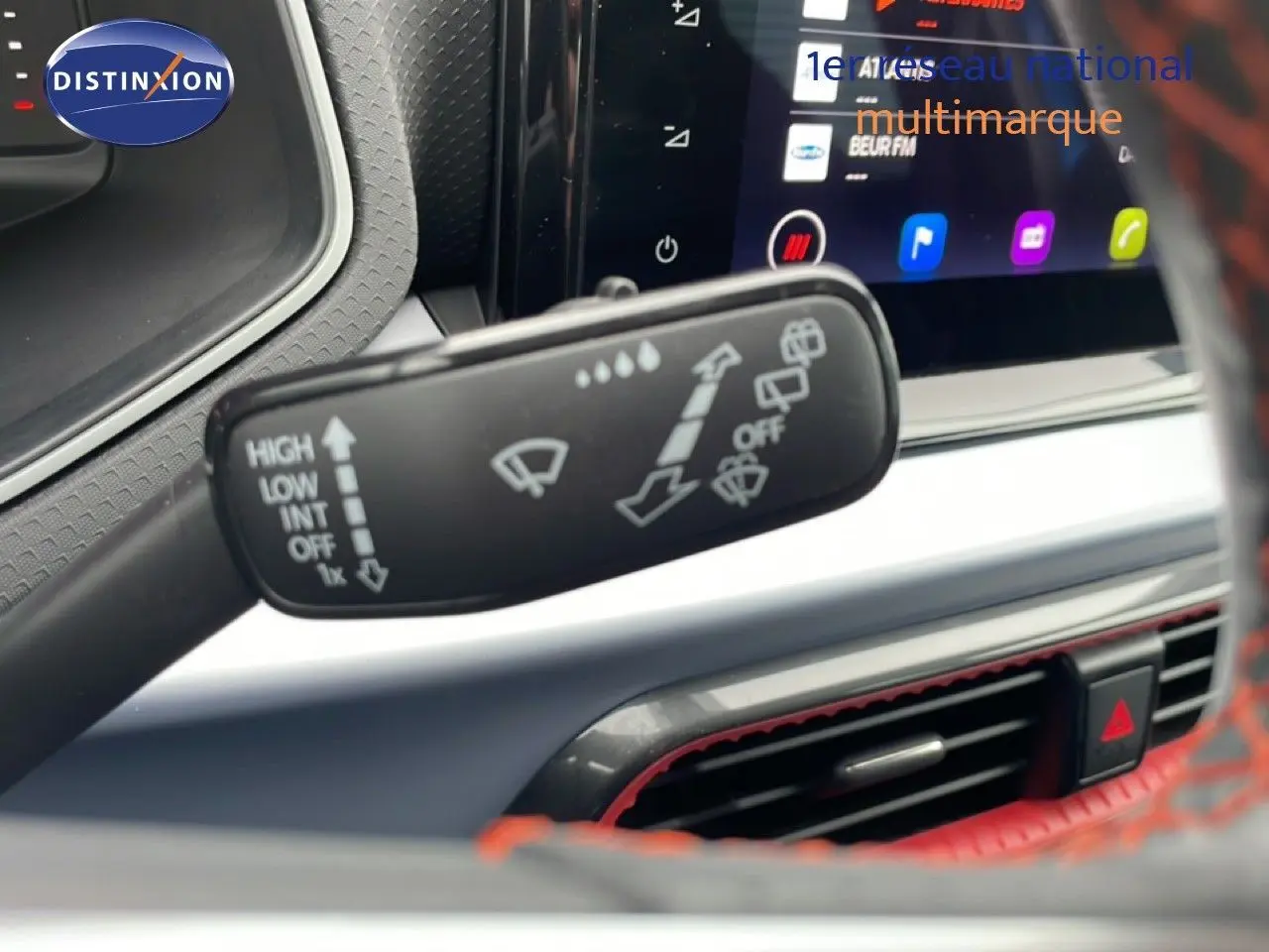 Gros plan sur la commande d’essuie-glace à gauche du volant dans l’habitacle du SEAT Arona bleu saphir 2025.