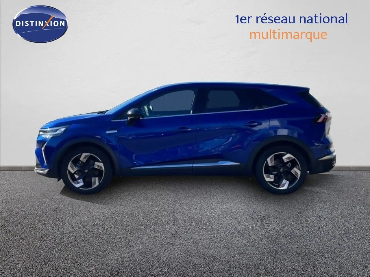 Profil droit d’un Renault Symbioz 2025 bleu iron metal, SUV hybride avec jantes alliage bicolores et lignes dynamiques.