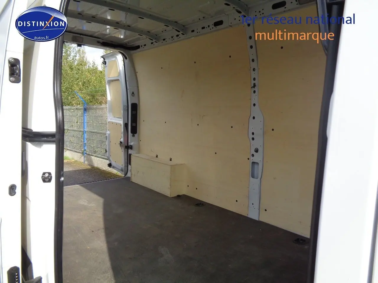 Vue intérieure du fourgon Opel Movano L3H2 blanc polaire, montrant l'espace de chargement vide avec parois boisées.