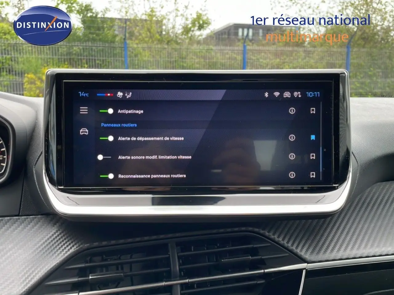Écran tactile central affichant les réglages d’aide à la conduite dans l’habitacle d’une Peugeot 208 gris Artense.