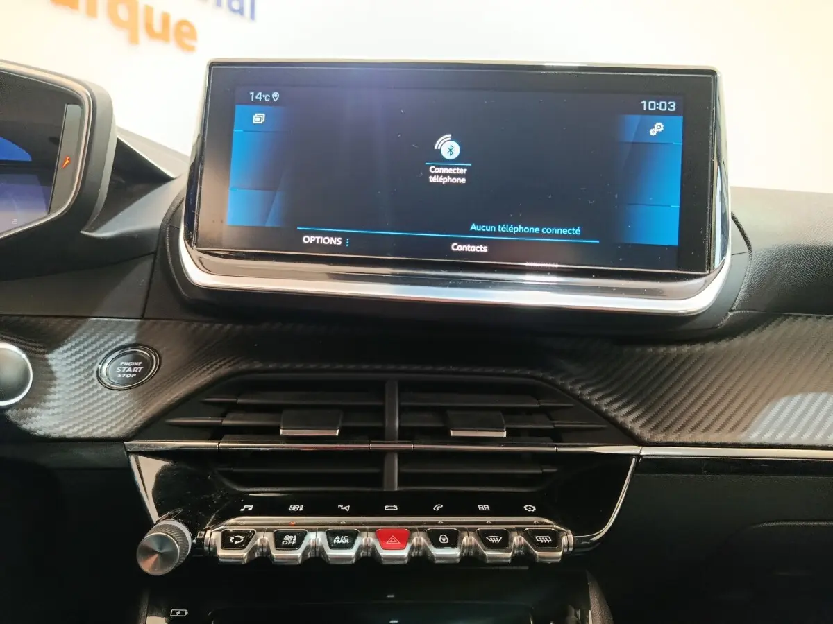 Vue rapprochée de l’écran tactile 10 pouces et de la console centrale noire à finition carbone du Peugeot 208 blanc.
