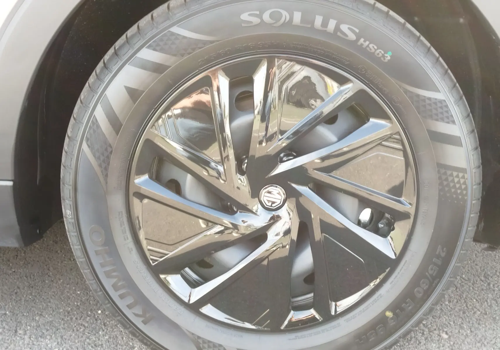 Gros plan sur la jante noire brillante et le pneu Kumho d’un MG ZS 1.5 L Hybrid+ 2026 couleur Hampstead Grey.