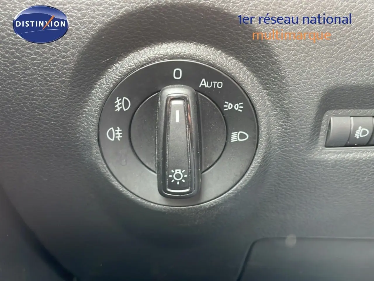 Gros plan sur la molette de réglage des phares dans l'habitacle d'une Skoda Fabia bleu énergie 2019.