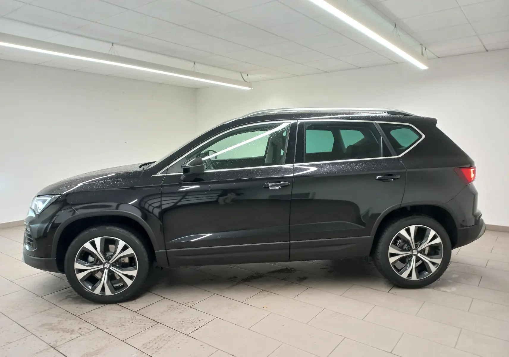 Vue latérale droite d'un SEAT Ateca 2.0 TDI 150 DSG7 Copa noir Magic Nacré avec jantes alliage 18 pouces usinées.