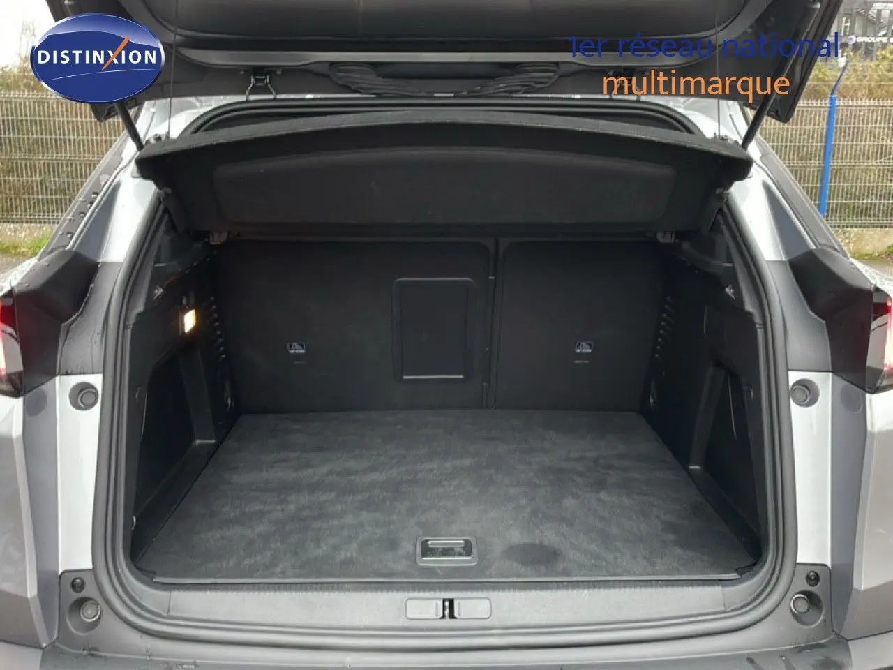 Coffre ouvert d'un Peugeot 3008 gris Artense métal, vue arrière montrant l'espace de chargement vide et propre.