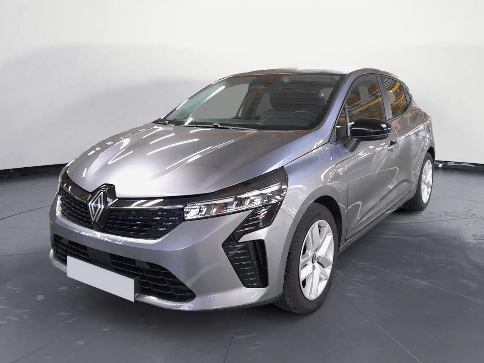 Renault Clio V E-Tech gris schiste vue 3/4 avant droit, avec projecteurs LED et calandre noire brillante.