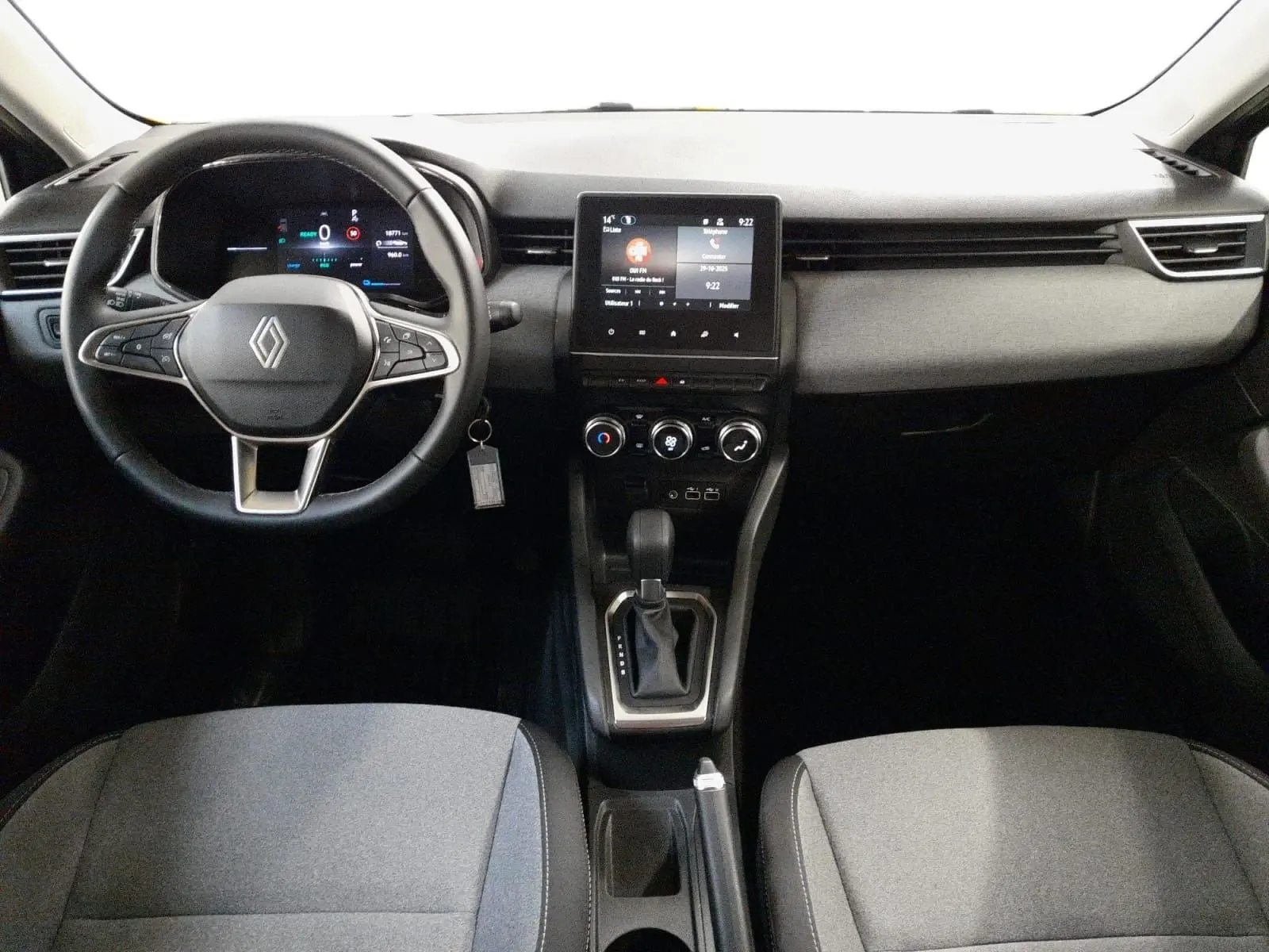 Vue intérieure frontale du tableau de bord de la Renault Clio V E-Tech gris schiste avec écran tactile et volant multifonction.