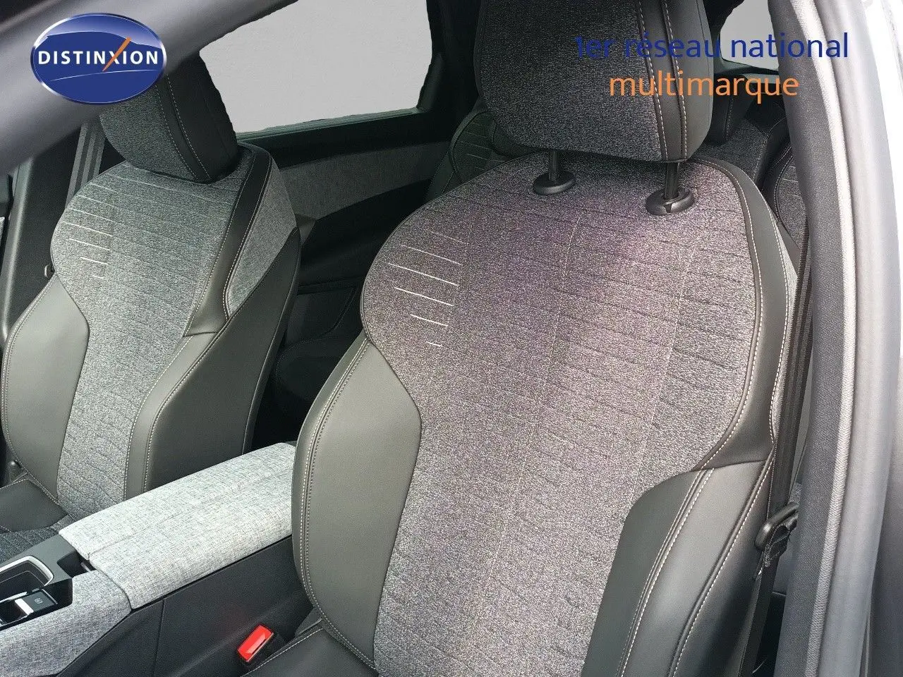 Gros plan sur les sièges avant en tissu gris et cuir noir du Peugeot 5008 1.2 Hybrid 2025, intérieur moderne et soigné.
