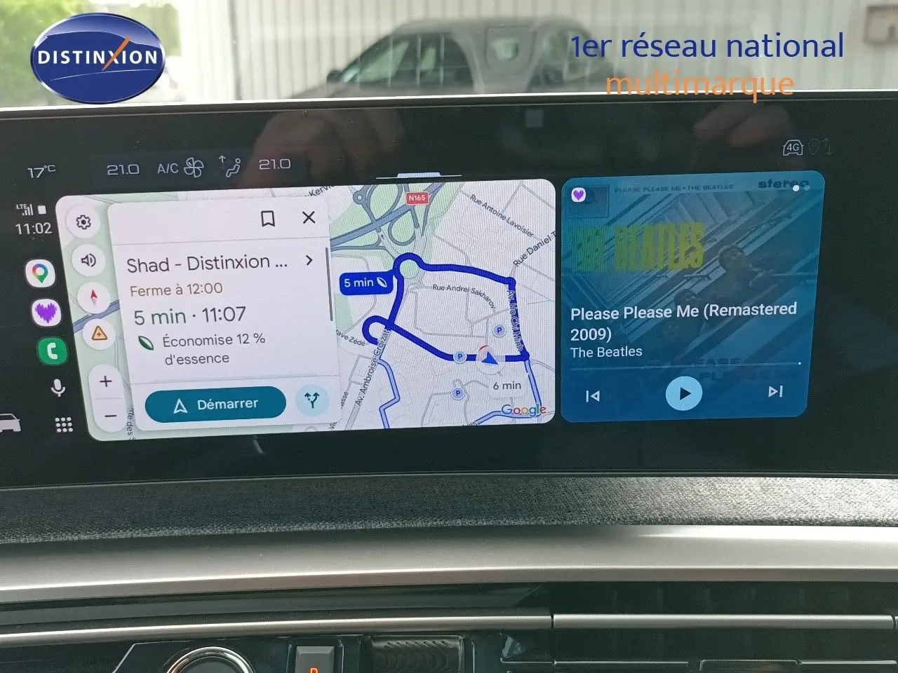 Vue rapprochée de l’écran tactile du tableau de bord du Peugeot 5008 gris titane, affichant navigation et musique.