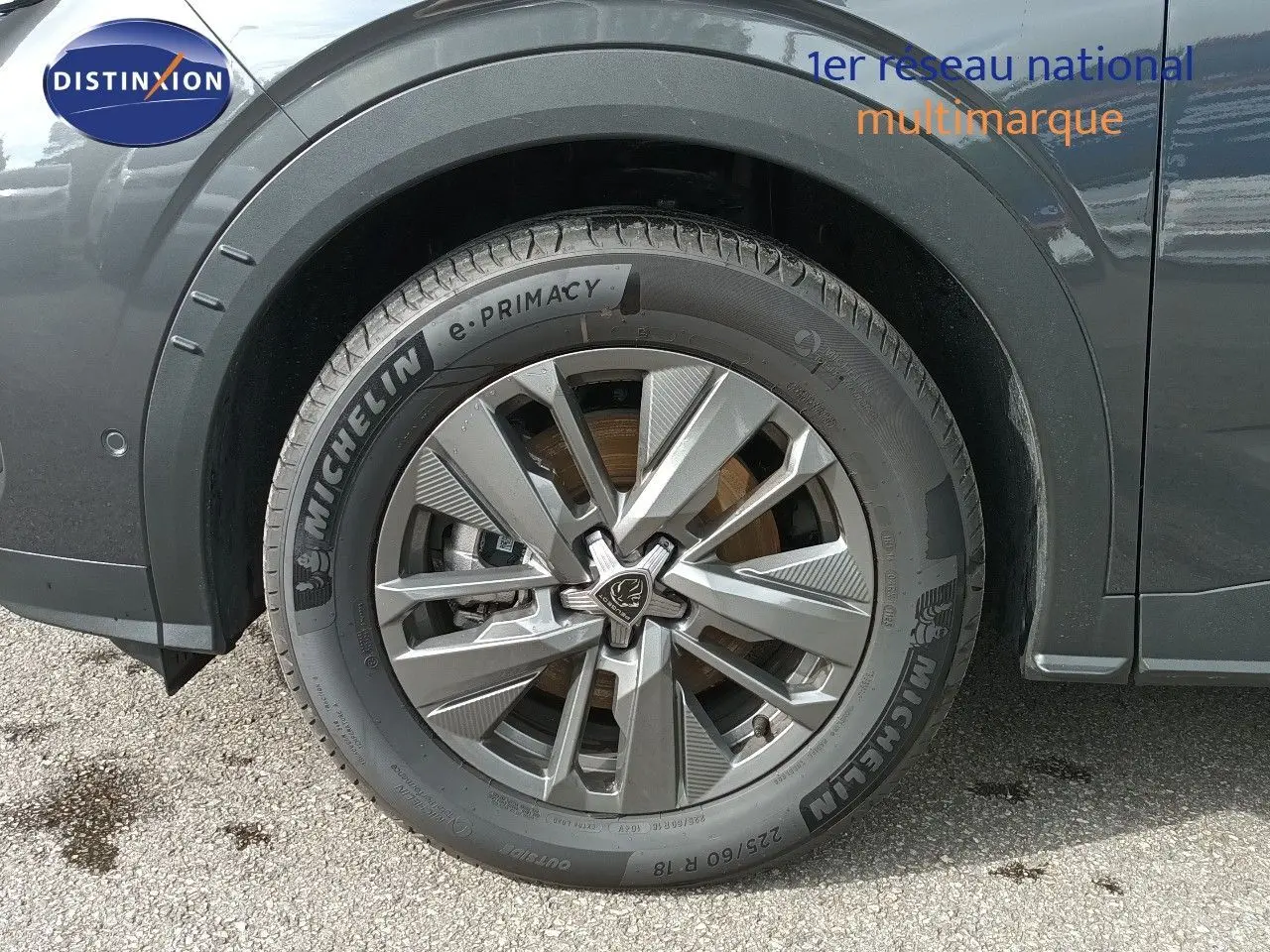 Gros plan sur la roue avant gauche du Peugeot 5008 gris titane métal, mettant en valeur la jante alliage et le pneu Michelin.