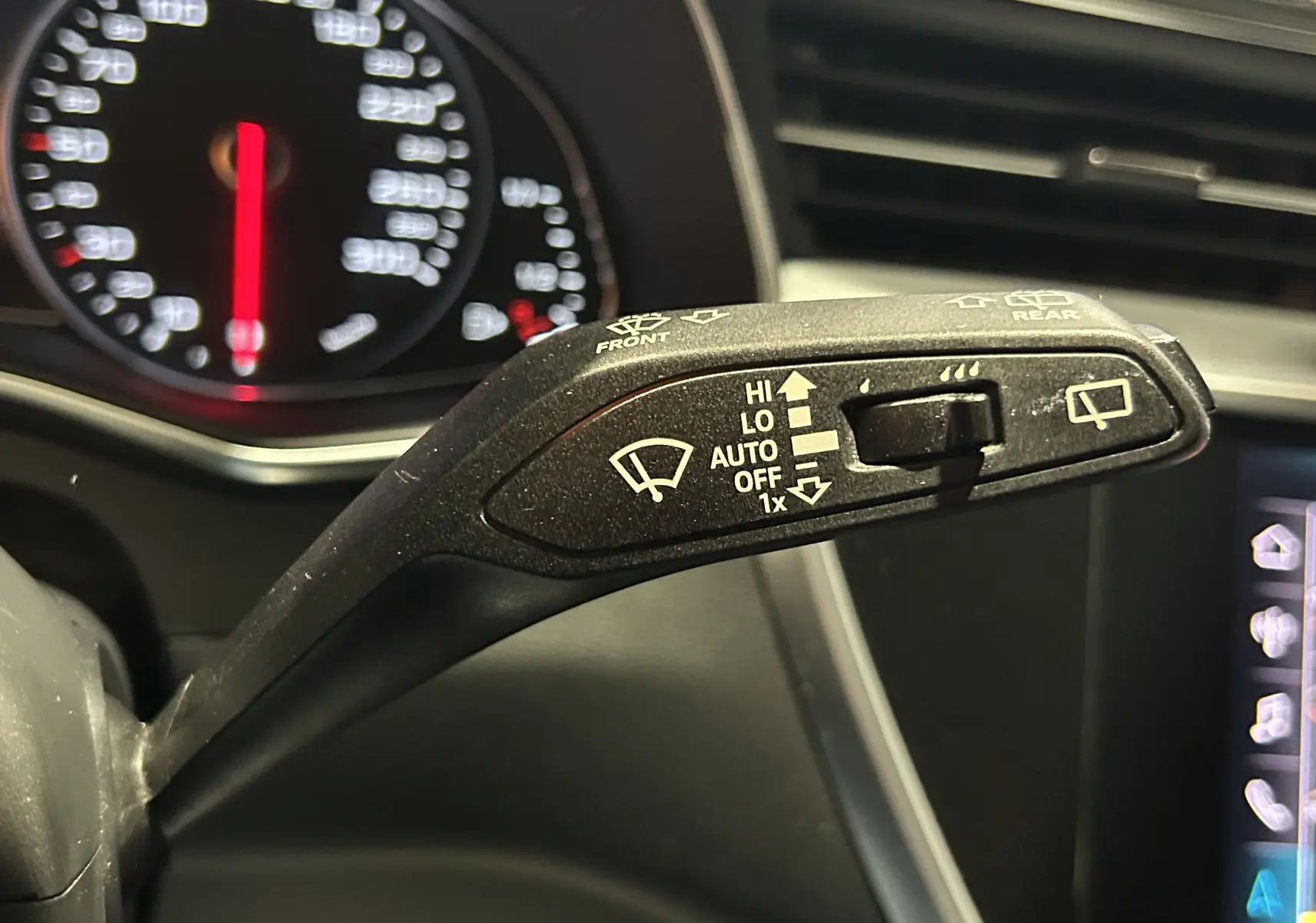 Le commodo d'essuie-glace en gros plan dans l'habitacle de l'Audi A6 Avant noire de 2019.