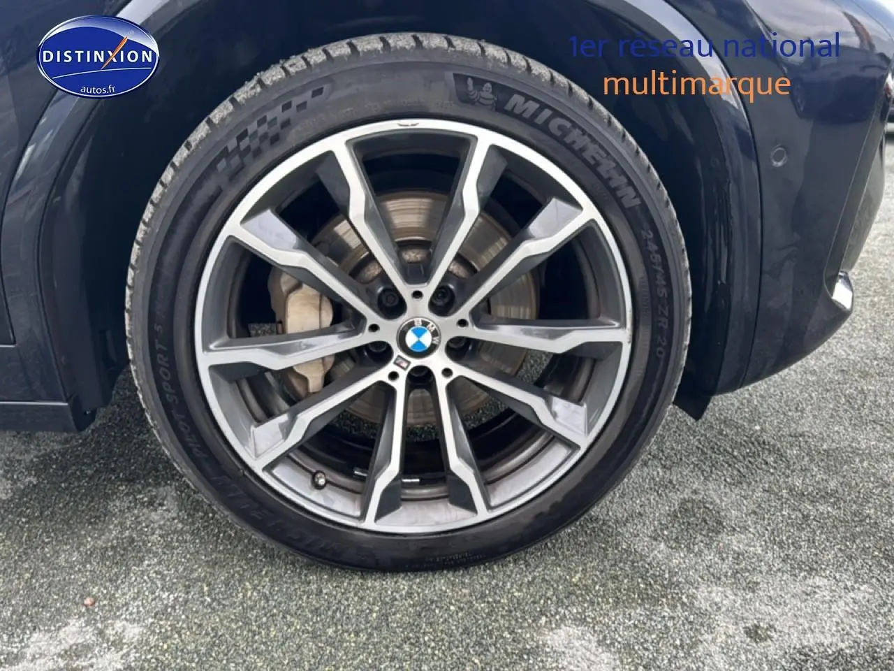 Gros plan sur la jante alu et pneu Michelin du côté avant droit d’un BMW X4 noir (g02) xdrive30d 286 M Sport.