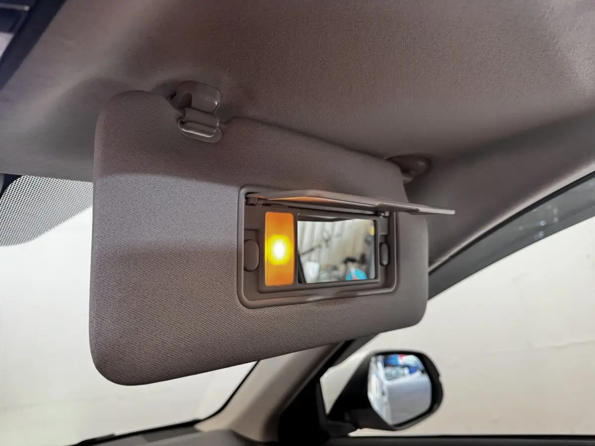 Détail intérieur du pare-soleil côté conducteur avec miroir éclairé dans un Honda HR-V blanc de 2019.