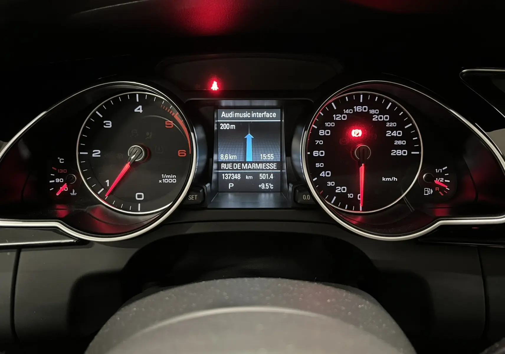 Vue rapprochée du tableau de bord noir d’une Audi A5 Sportback 2015, affichage numérique et compteurs analogiques.