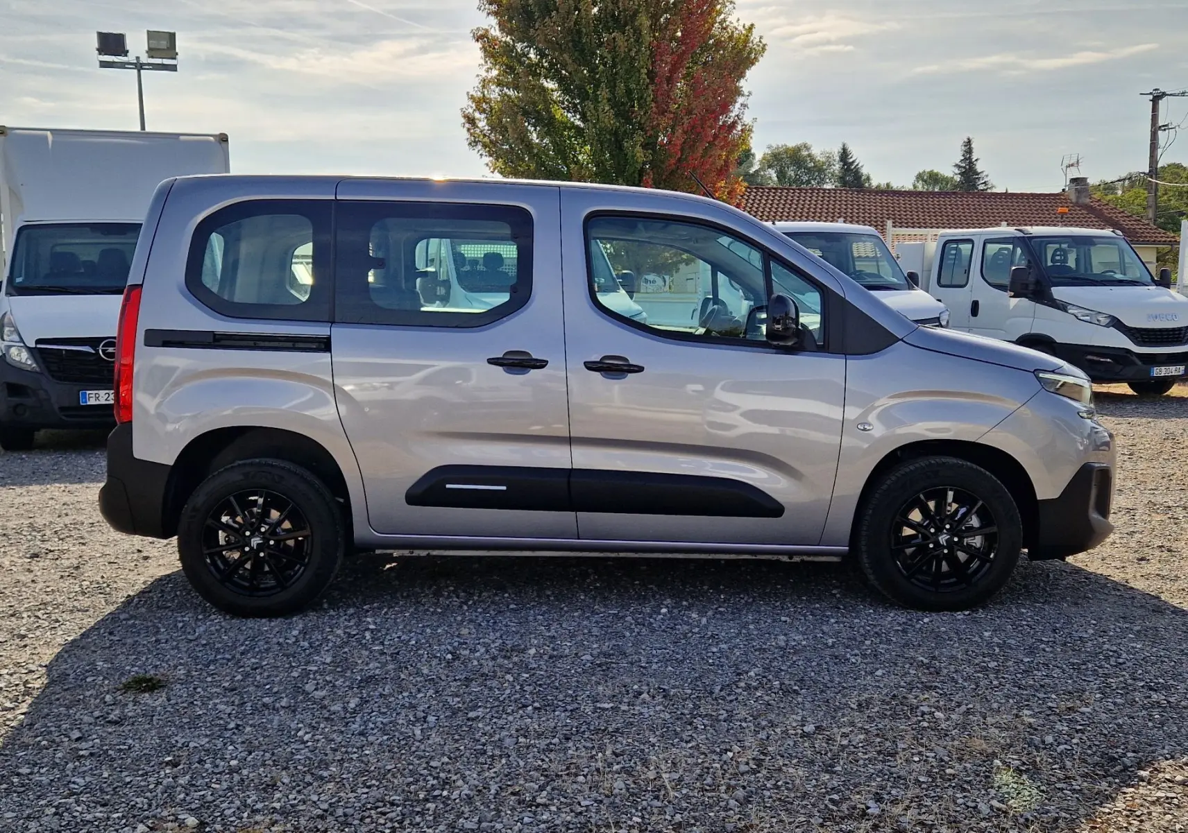 Profil droit du Citroën Berlingo gris Artense 2025 avec jantes noires et grille de séparation visible à l'intérieur.