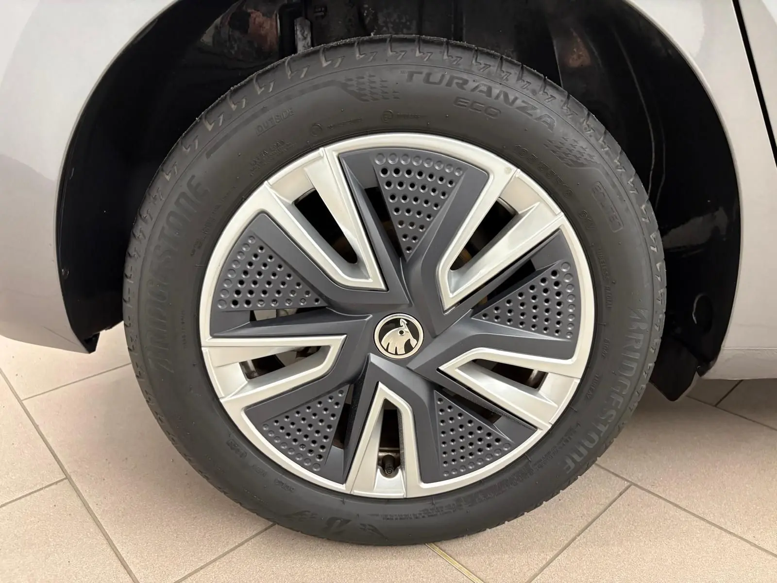 Gros plan sur la roue avant droite d’une Skoda Fabia 2023 gris graphite avec jante alliage au design moderne.