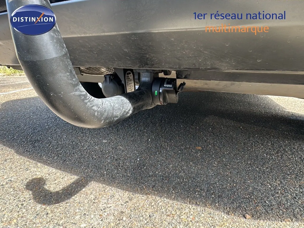 Gros plan sous l'arrière d'une Renault Rafale blanche satin avec attelage visible en partie basse.