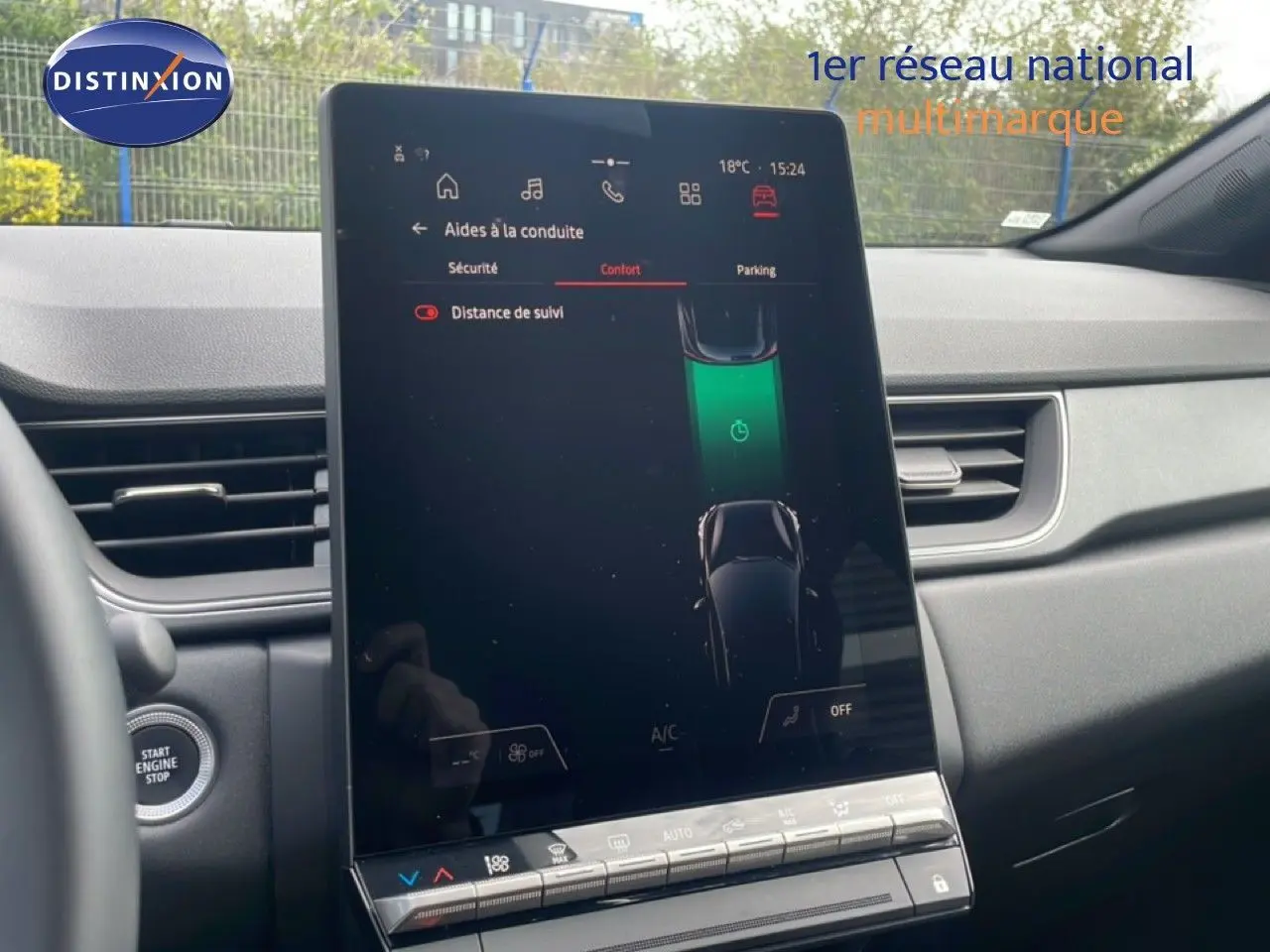Vue intérieure centrée sur l'écran tactile vertical du tableau de bord du Renault Captur gris cassiopée métal avec toit noir.