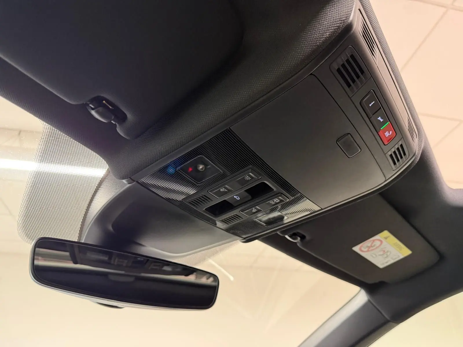 Vue intérieure du toit ouvrant et du plafonnier noir avec rétroviseur intérieur du Volkswagen Taigo blanc toit noir.