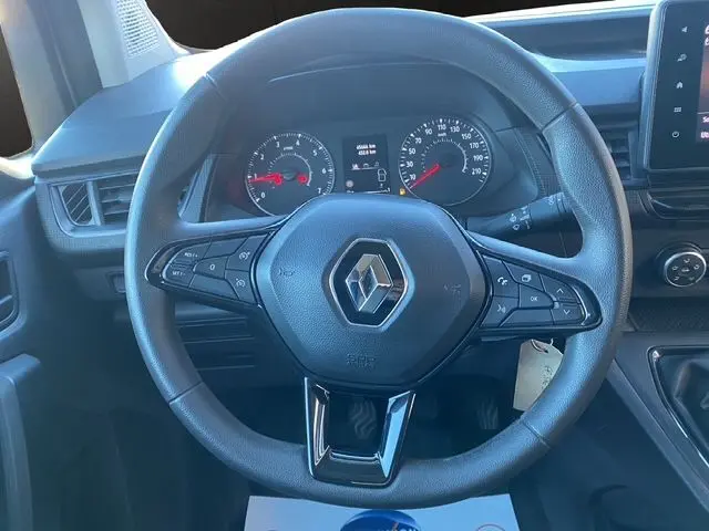 Vue frontale du volant noir de Renault Kangoo 2023, tableau de bord avec compteurs et commandes intégrées.