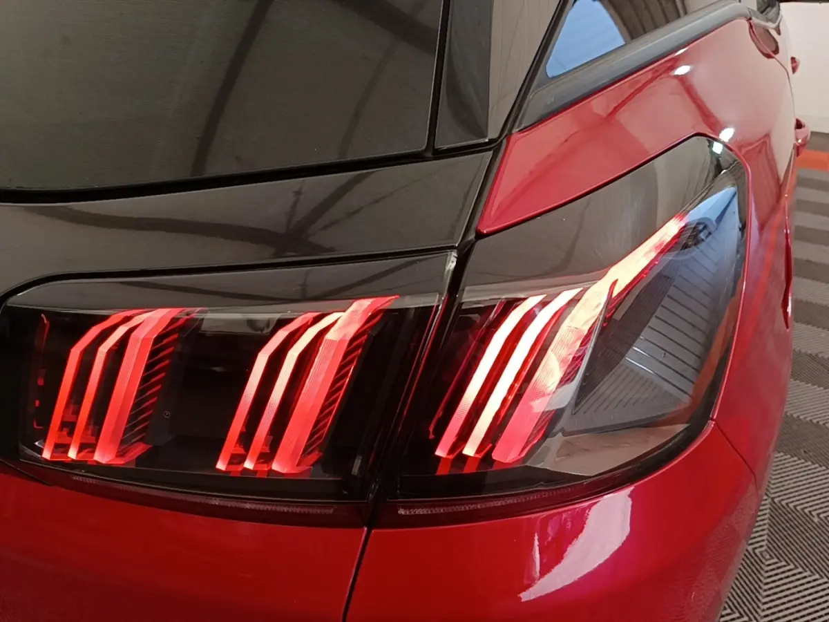 Gros plan sur le feu arrière droit rouge et noir du Peugeot 3008 PureTech 130 S&S Allure 2021, finition bicolore.