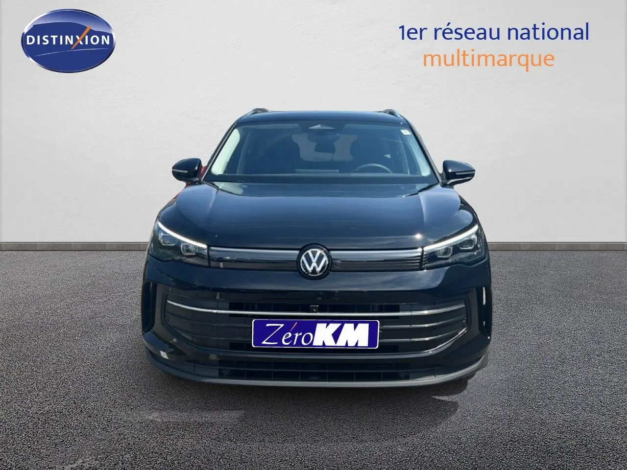 Vue frontale du Volkswagen Tiguan noir Grenadilla 2026 avec calandre moderne et logo centré, sur fond neutre.