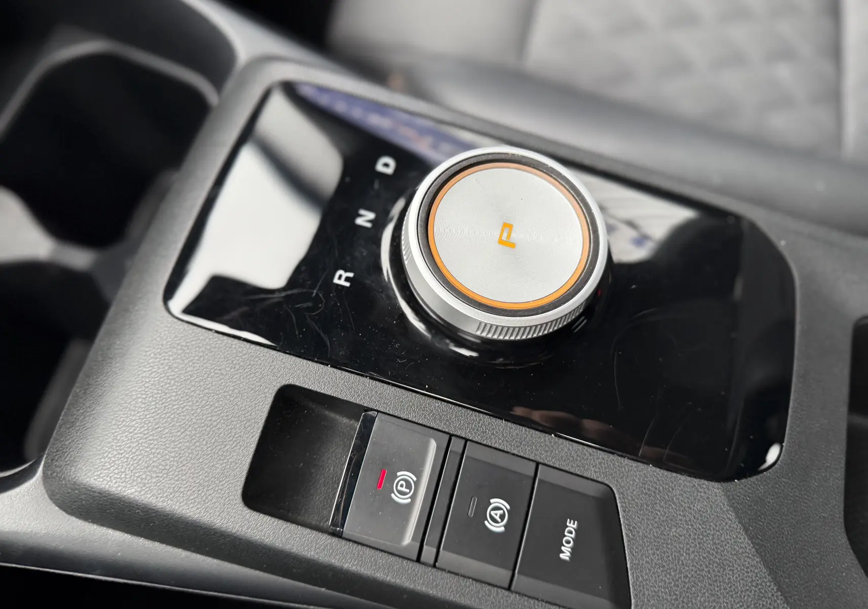 Gros plan sur la molette de sélection de vitesse et les boutons de commande sur la console centrale noire du MG3 1.5 HYBRID+ 195 LUXURY.