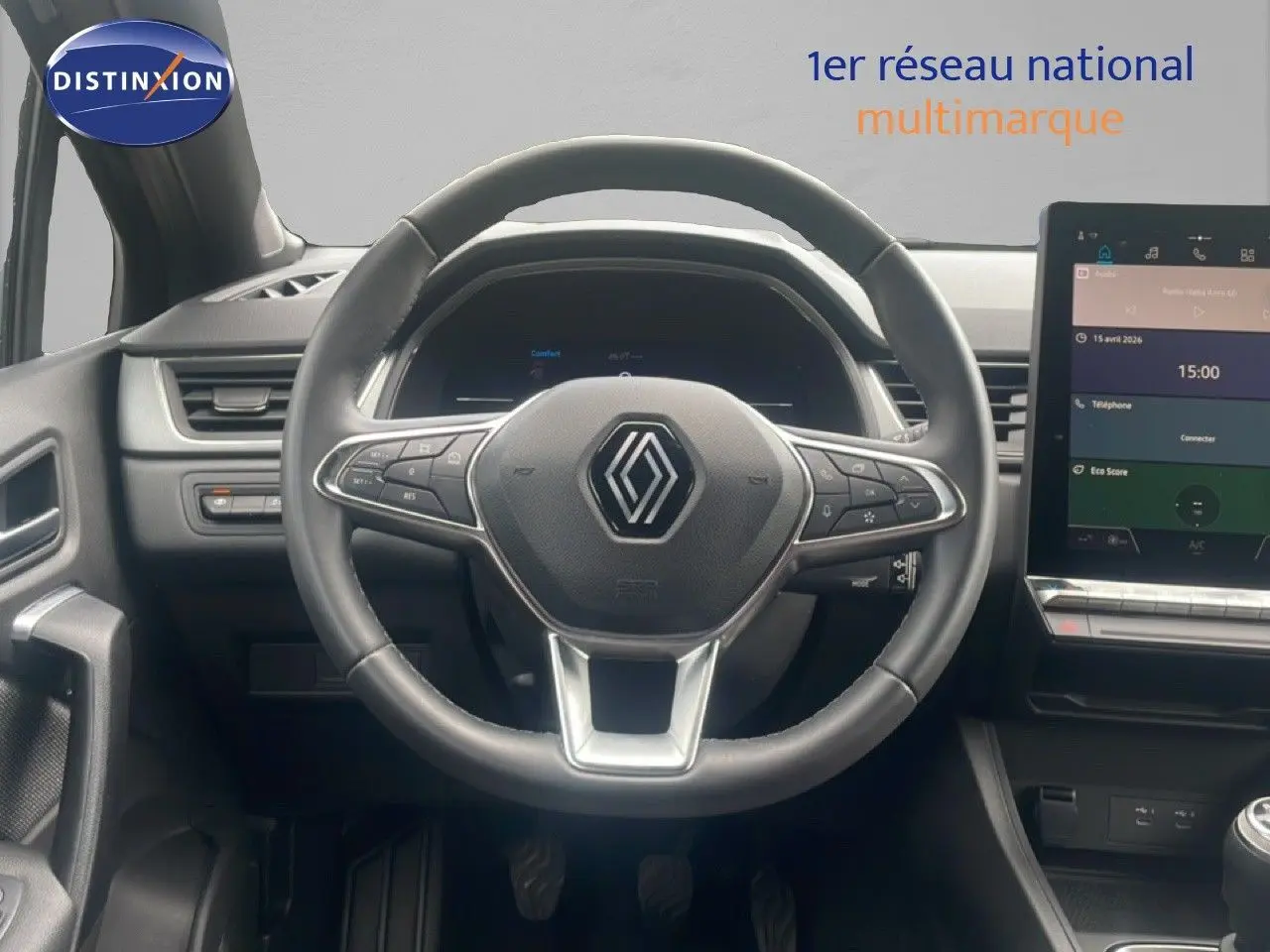 Intérieur Renault Captur 2025 vu du poste de conduite, volant multifonction et écran tactile central visible.