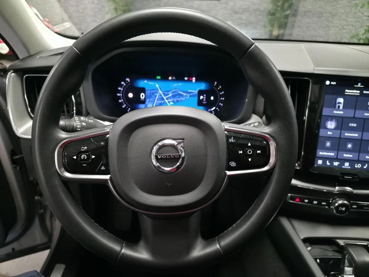 Volant cuir noir Volvo XC60 2023 vu de face avec tableau de bord digital et écran tactile central.