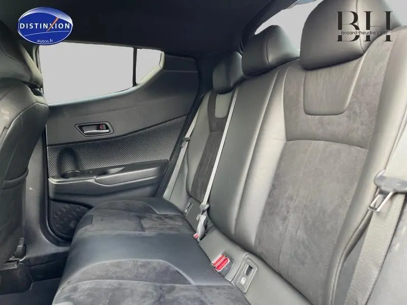 Vue latérale intérieure montrant la banquette arrière en cuir et alcantara noir du Toyota C-HR blanc nacré 2019.