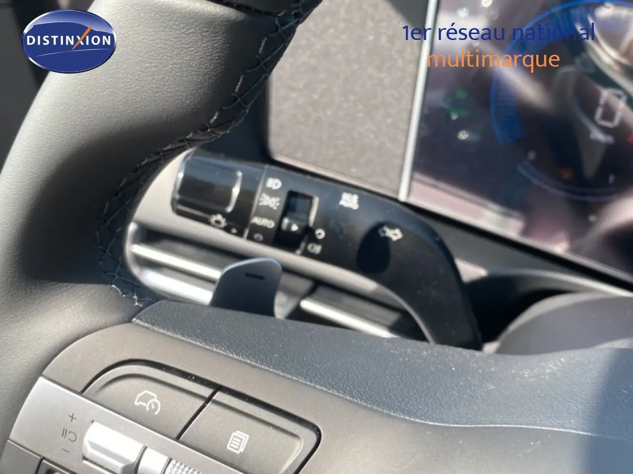 Gros plan sur le volant noir et les commandes intégrées du Hyundai Tucson 2026 gris Ecotronic Metal.