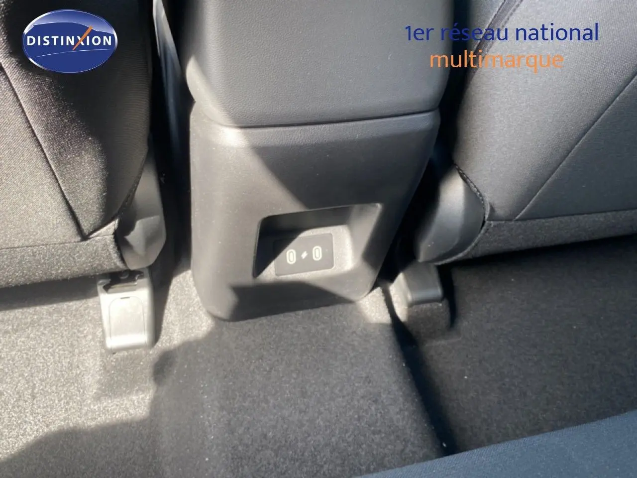 Vue rapprochée de la console arrière entre les sièges arrière d’un Hyundai Tucson gris Ecotronic Metal.