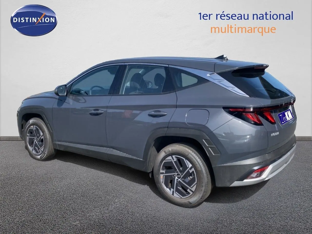 Vue 3/4 arrière droite du Hyundai Tucson gris Ecotronic Metal avec jantes bi-ton et feux LED distinctifs.