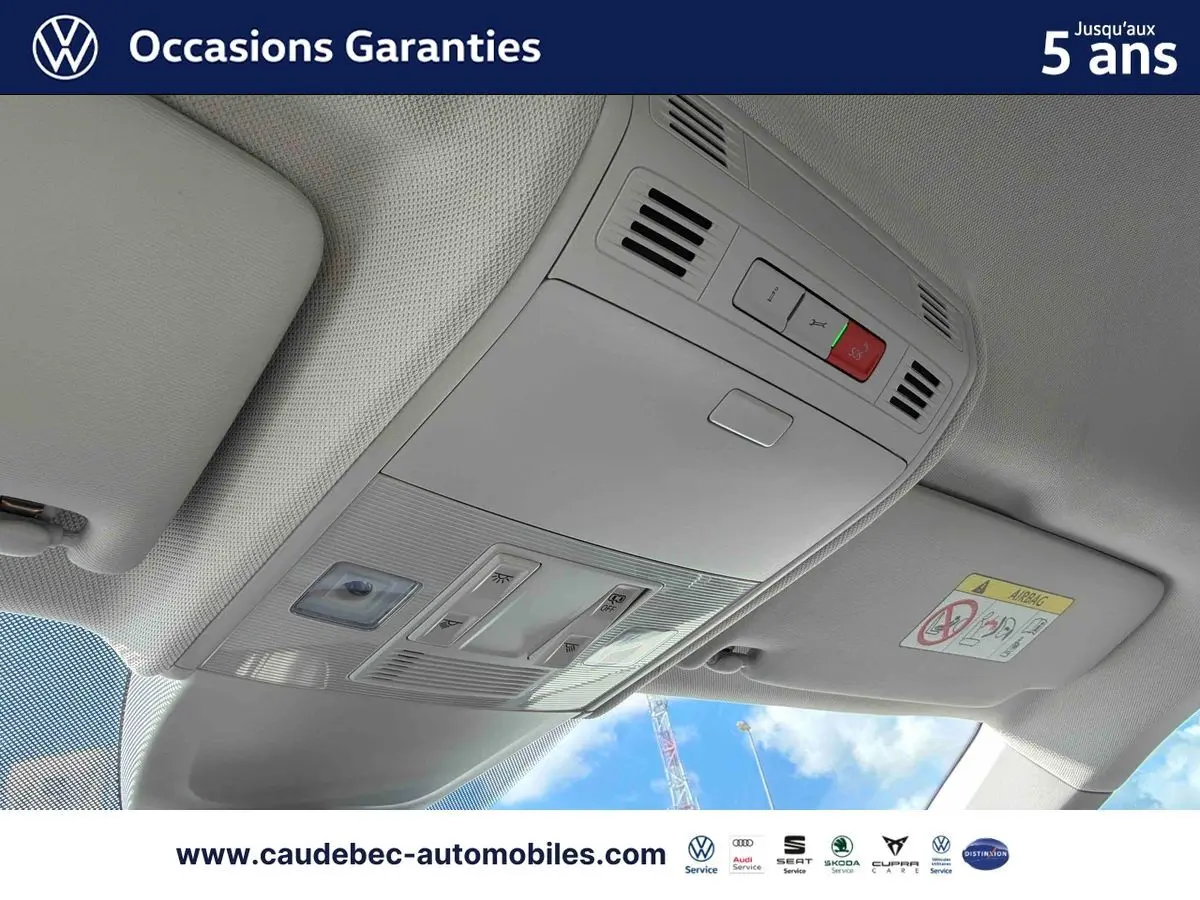 Plafonnier intérieur gris clair avec commandes d’éclairage et bouton SOS, vue depuis l’avant du Volkswagen Polo noir intense nacré.