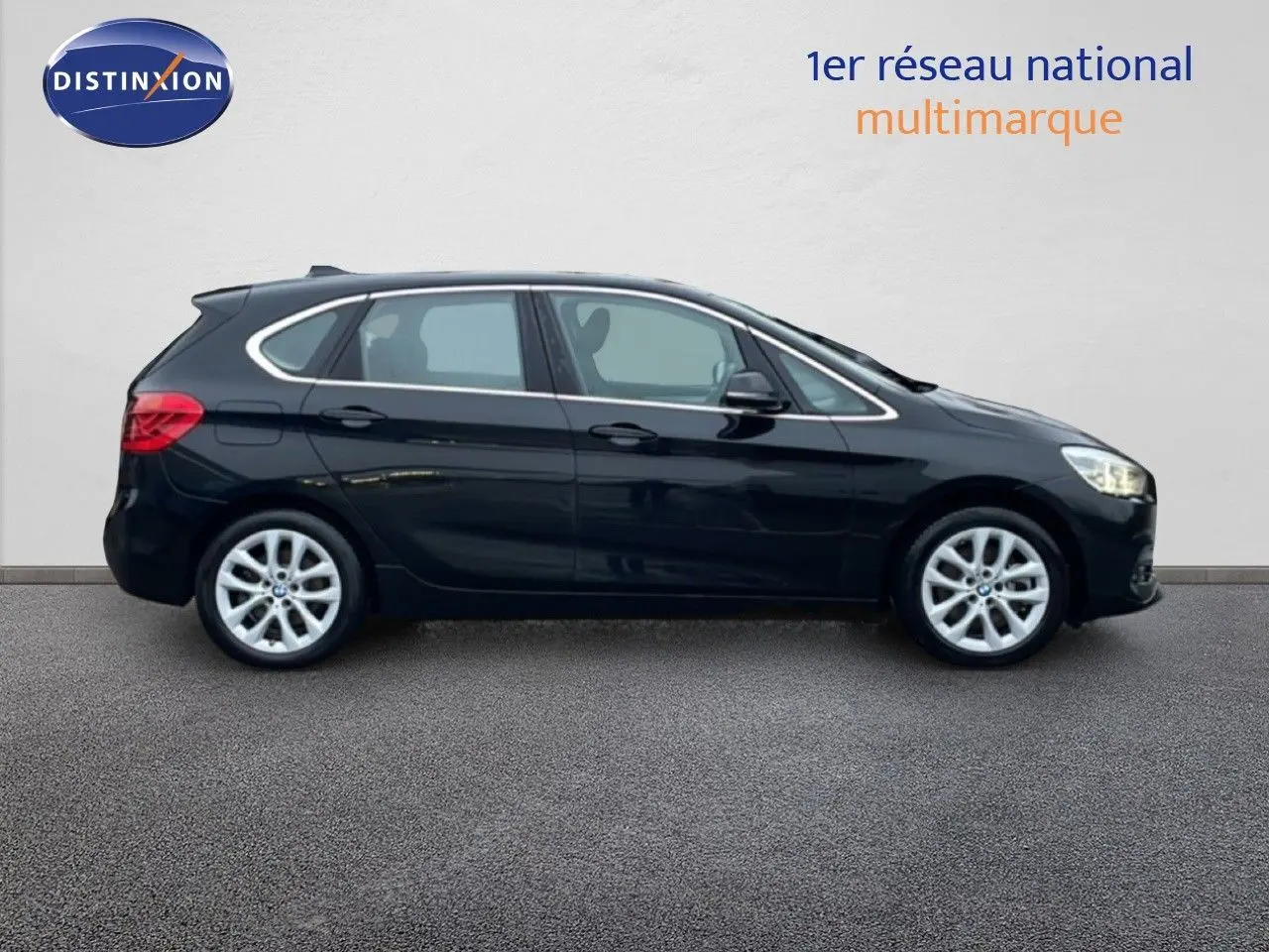 BMW Série 2 Active Tourer noir saphir métal vue de profil côté gauche sur fond neutre, jantes alliage visibles.