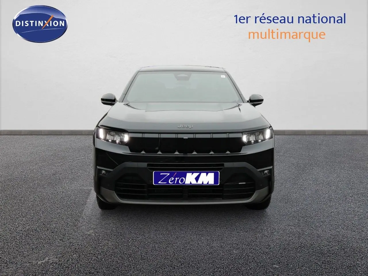 Vue frontale d'un Jeep Compass noir Vulcano métal 2026 avec calandre noire et phares allumés sur fond neutre.