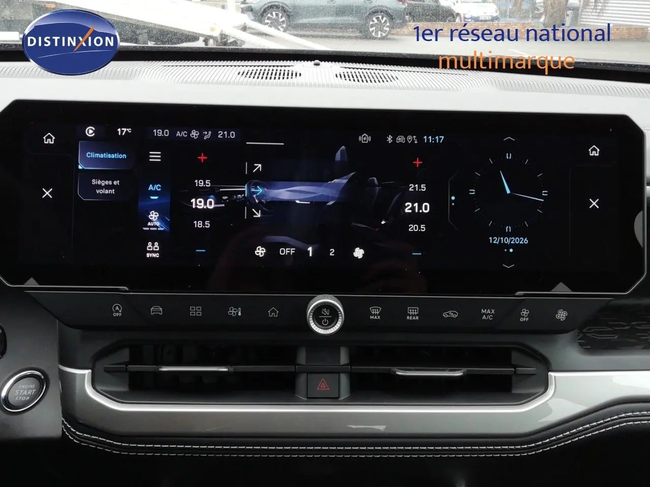 Vue rapprochée de l’écran tactile central du Jeep Compass 2026 noir Vulcano, affichant la climatisation et l’horloge digitale.