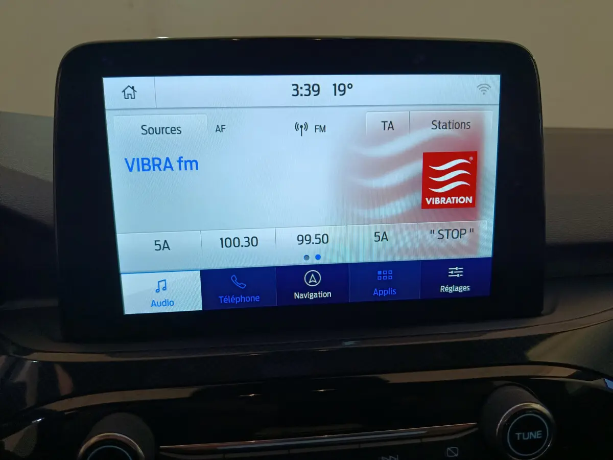 Écran tactile central du tableau de bord du Ford Kuga 2024 affichant la radio VIBRA fm en mode audio.