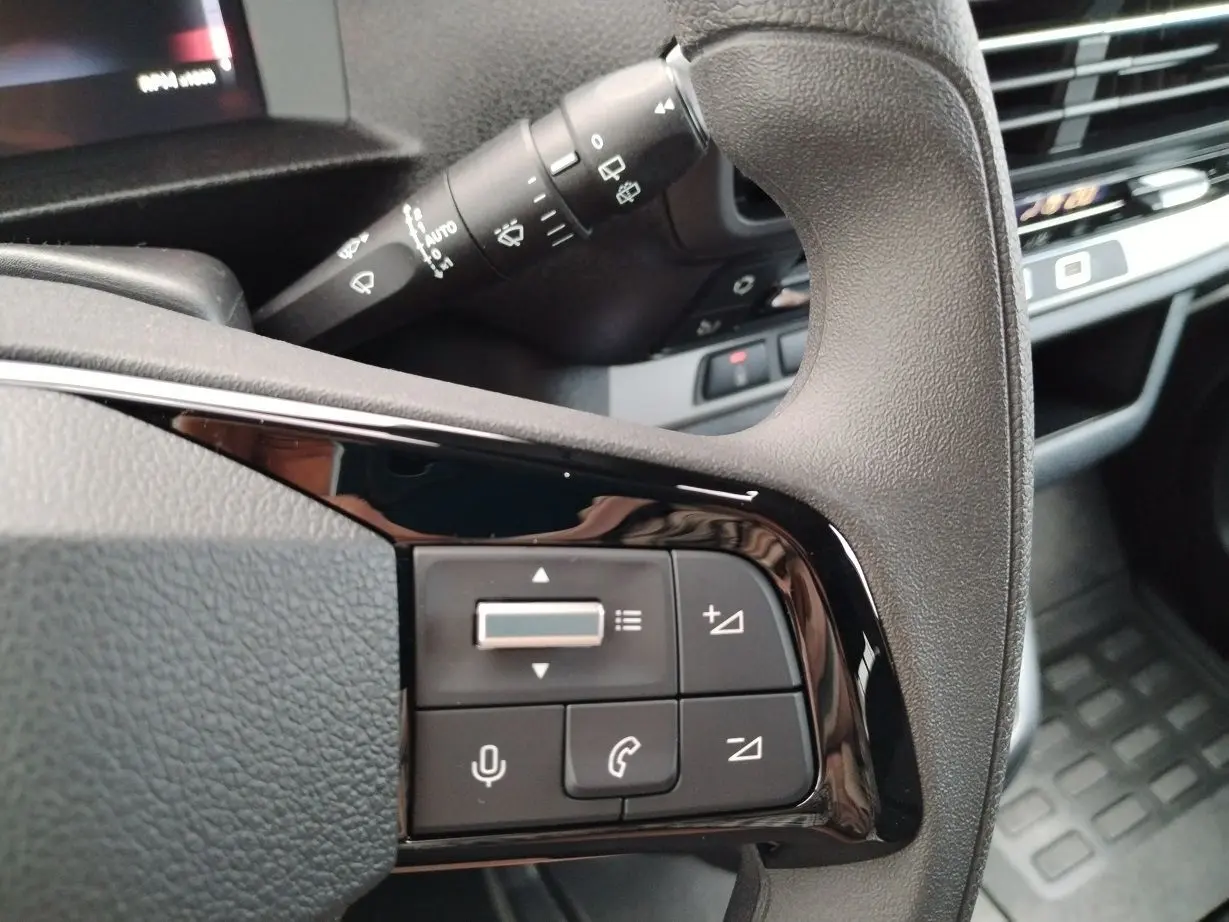 Gros plan sur les commandes noires au volant du FIAT ULYSSE XL 2026, avec levier d'essuie-glace en arrière-plan.