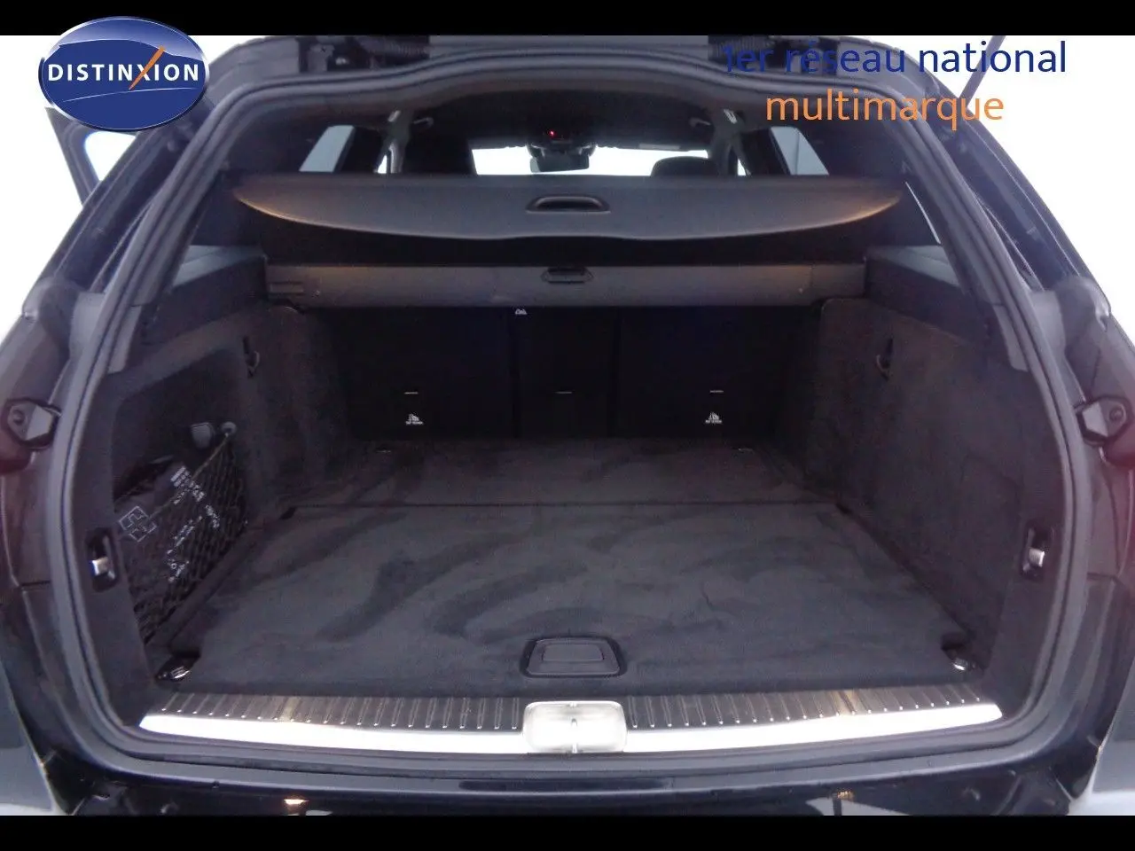 Coffre ouvert en vue arrière d'un Mercedes Classe C Break 220D noir métal, avec cache-bagages et intérieur spacieux.