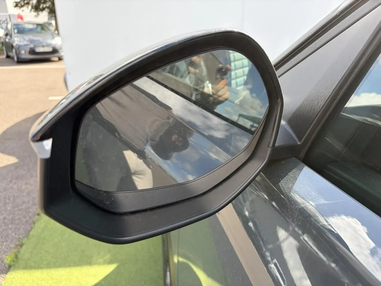 Rétroviseur extérieur droit noir brillant du Citroën C5 Aircross Vert Astoria avec toit noir, vue rapprochée côté conducteur.