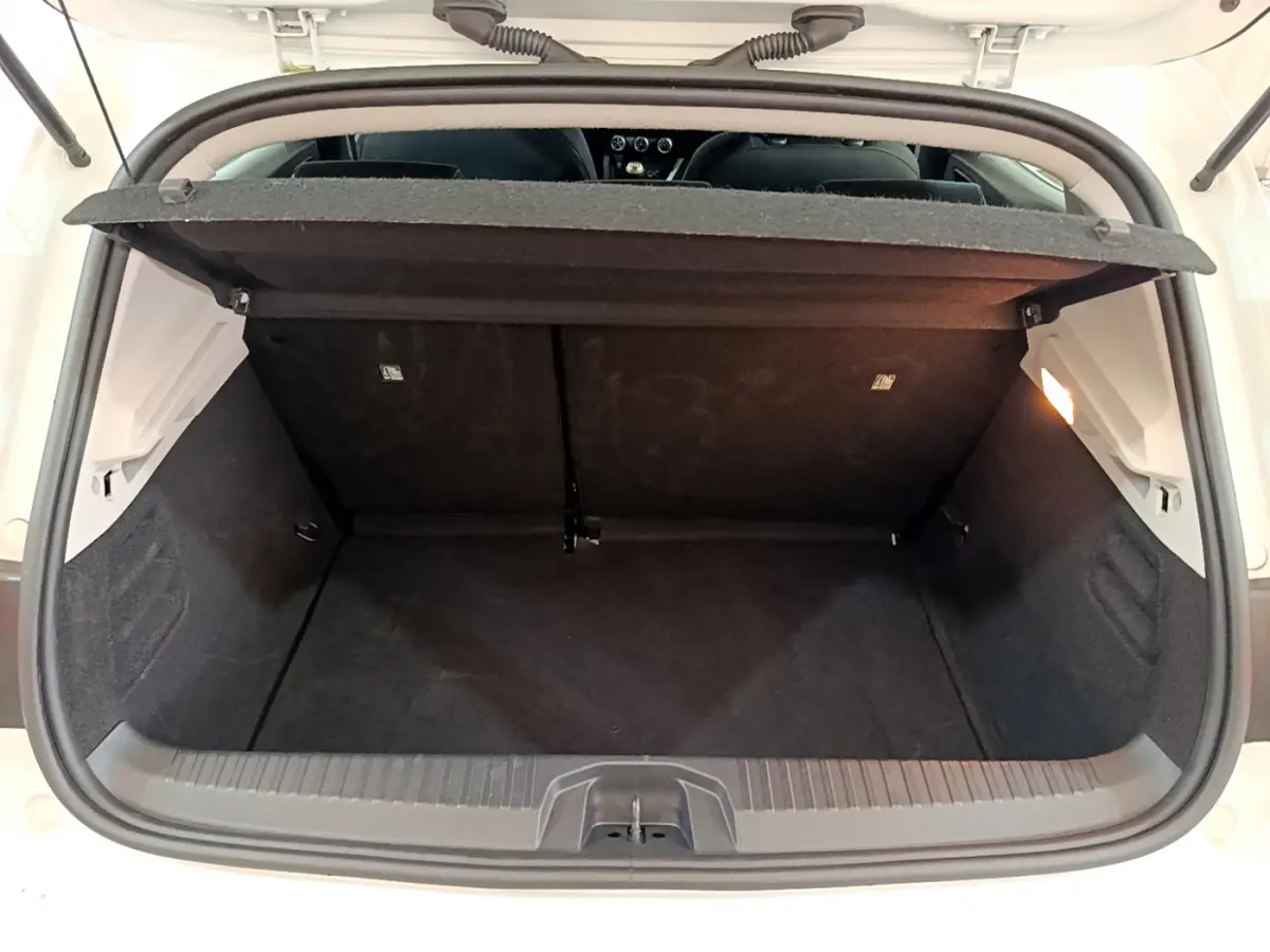 Coffre ouvert d'une Renault Clio blanche 2020, vue arrière, montrant l'espace de chargement et la tablette cache-bagages.