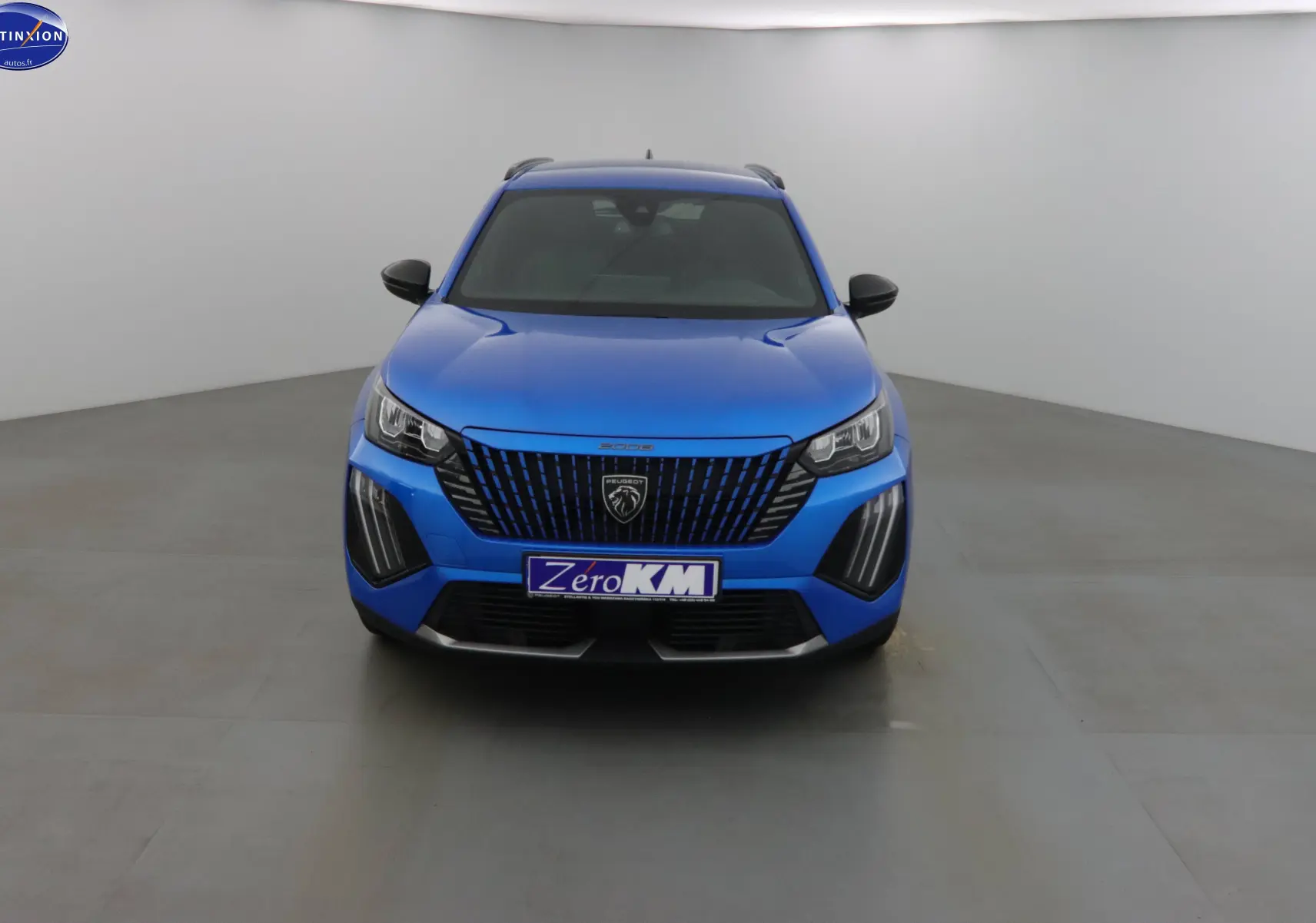 Vue frontale d'un Peugeot 2008 bleu Vertigo Metal avec calandre noire et feux LED distinctifs.