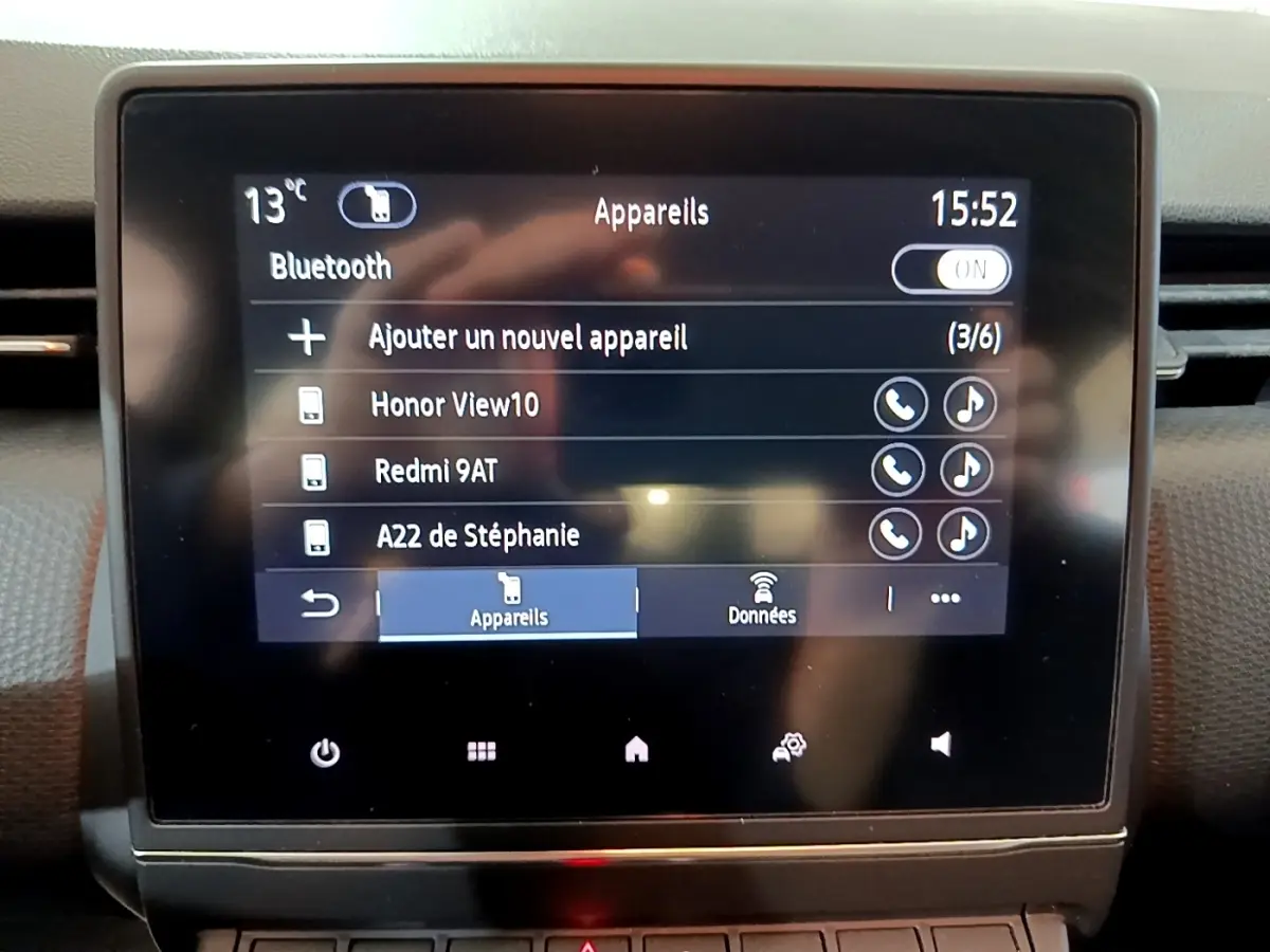 Écran tactile central de la Renault Clio Business blanc, affichant la connexion Bluetooth et liste des appareils associés.
