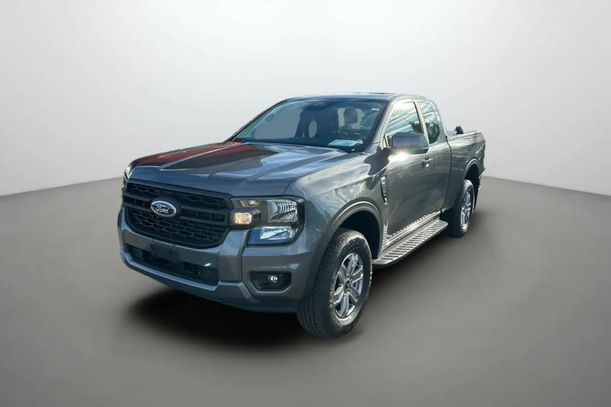 Ford Ranger gris carbone en 3/4 avant droit avec marchepieds latéraux et calandre noire.