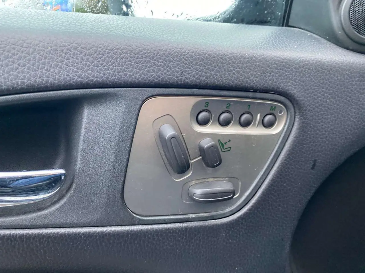 Panneau de réglage des sièges avec mémoire sur la portière côté gauche d'une Jaguar XK gris clair 2009.