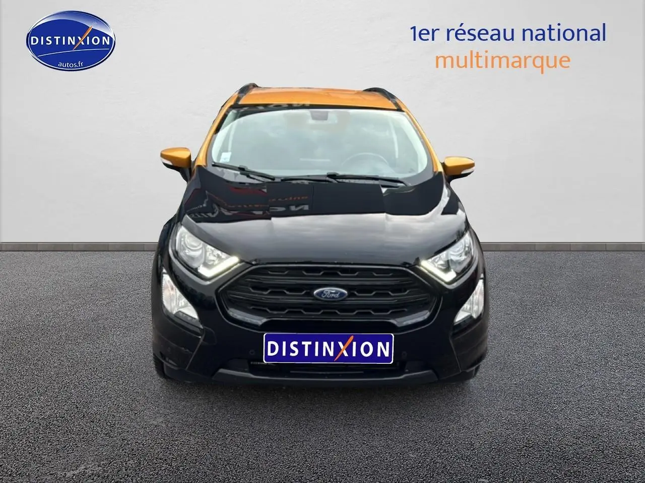 Vue avant d'un Ford EcoSport noir avec toit et rétroviseurs orange, calandre noire et phares allumés.