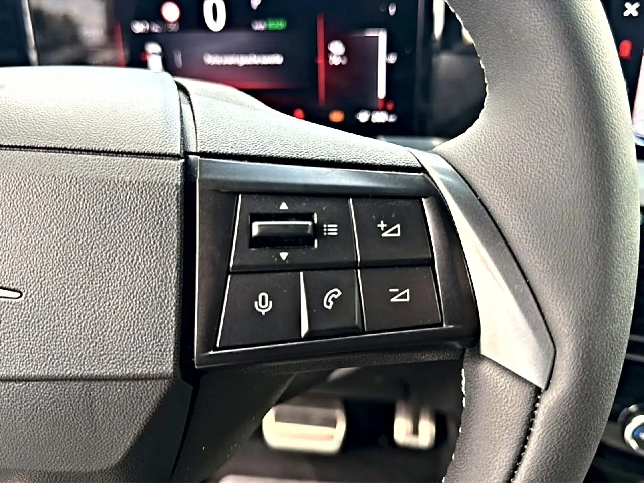 Gros plan sur les commandes noires du volant côté gauche de l’Opel Mokka Electric 156 gs 2025.