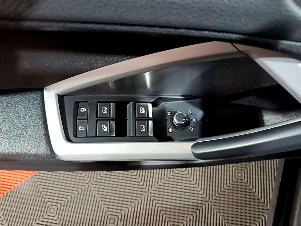 Commande des vitres électriques et réglage des rétroviseurs sur la porte côté conducteur de l'Audi Q3 noir.