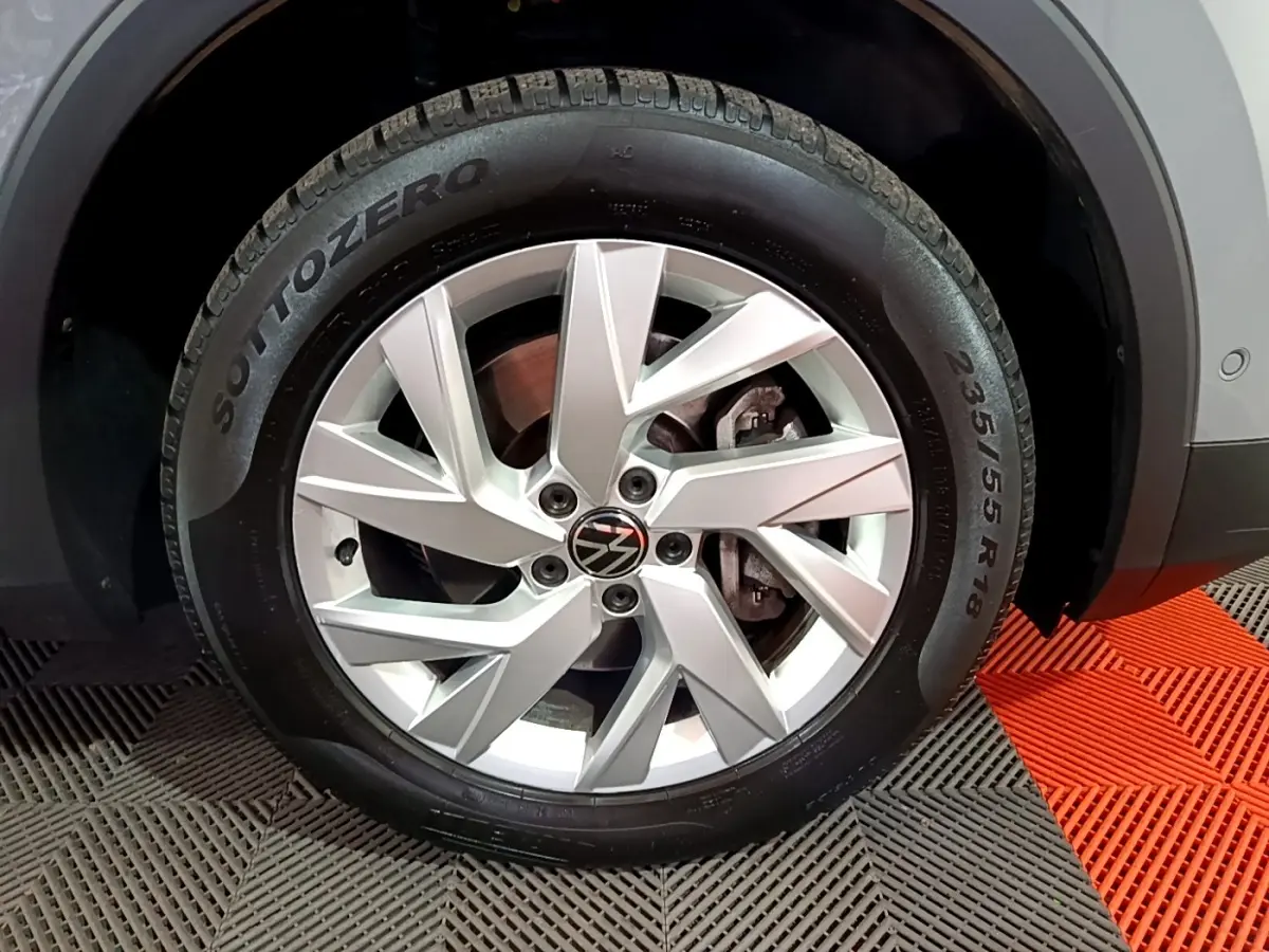 Gros plan sur la jante alliage argentée et pneu Pirelli Sottozero du Volkswagen Tiguan gris foncé, côté droit.
